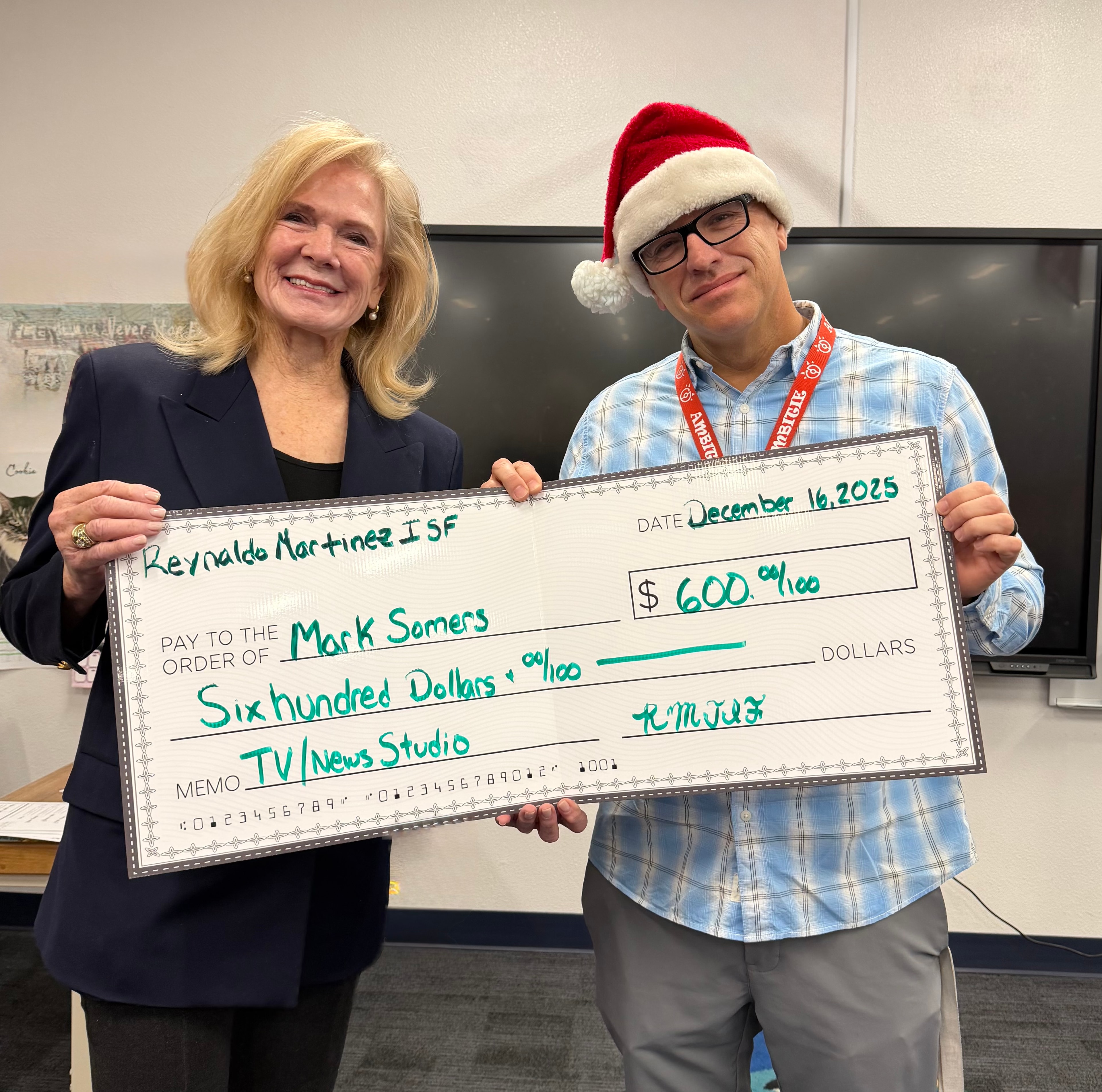 Mark Somers receiving a $600 grant for TV / News Studio