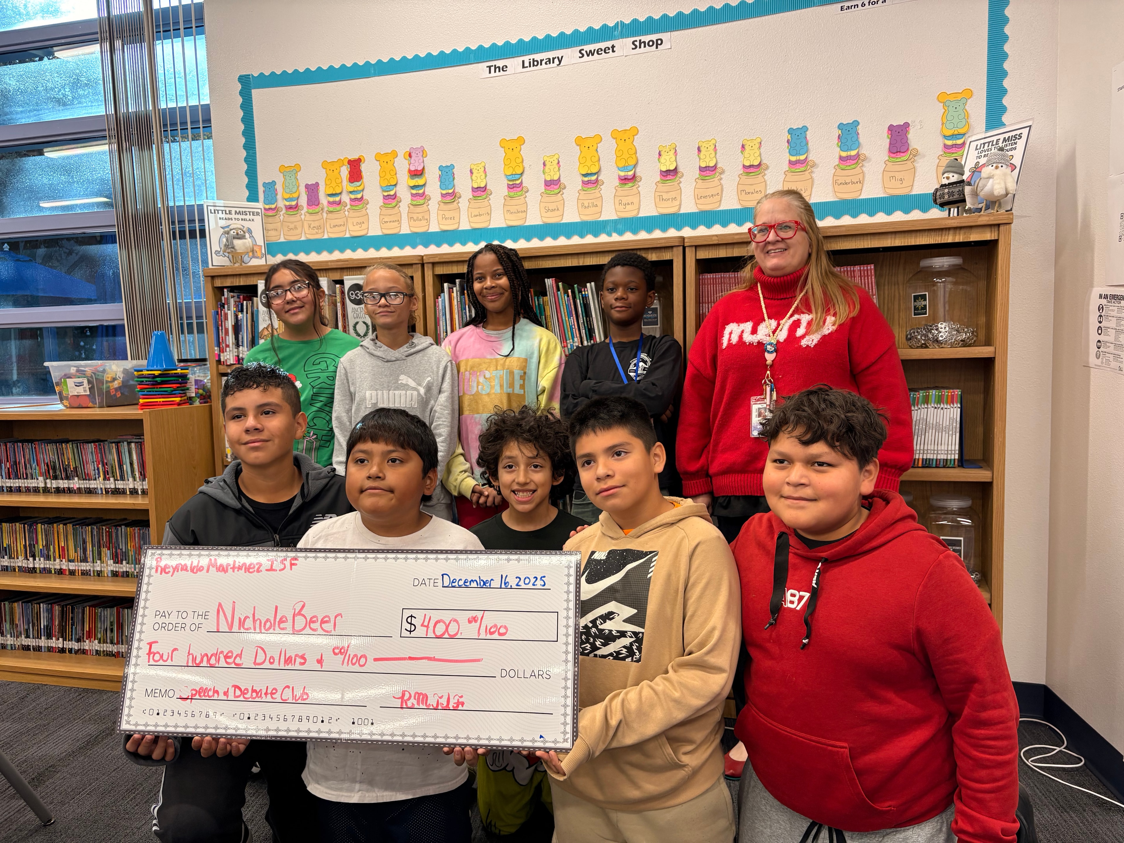 Nichole Beer receiving a $400 grant for Speech & Debate Club